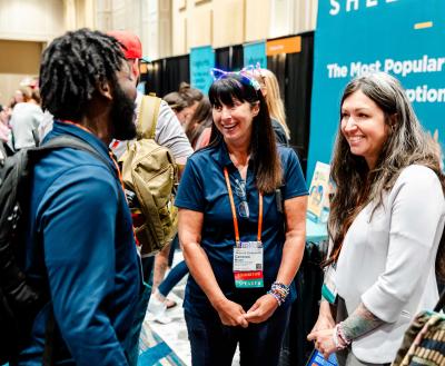 Three people networking at the Best Friends National Conference