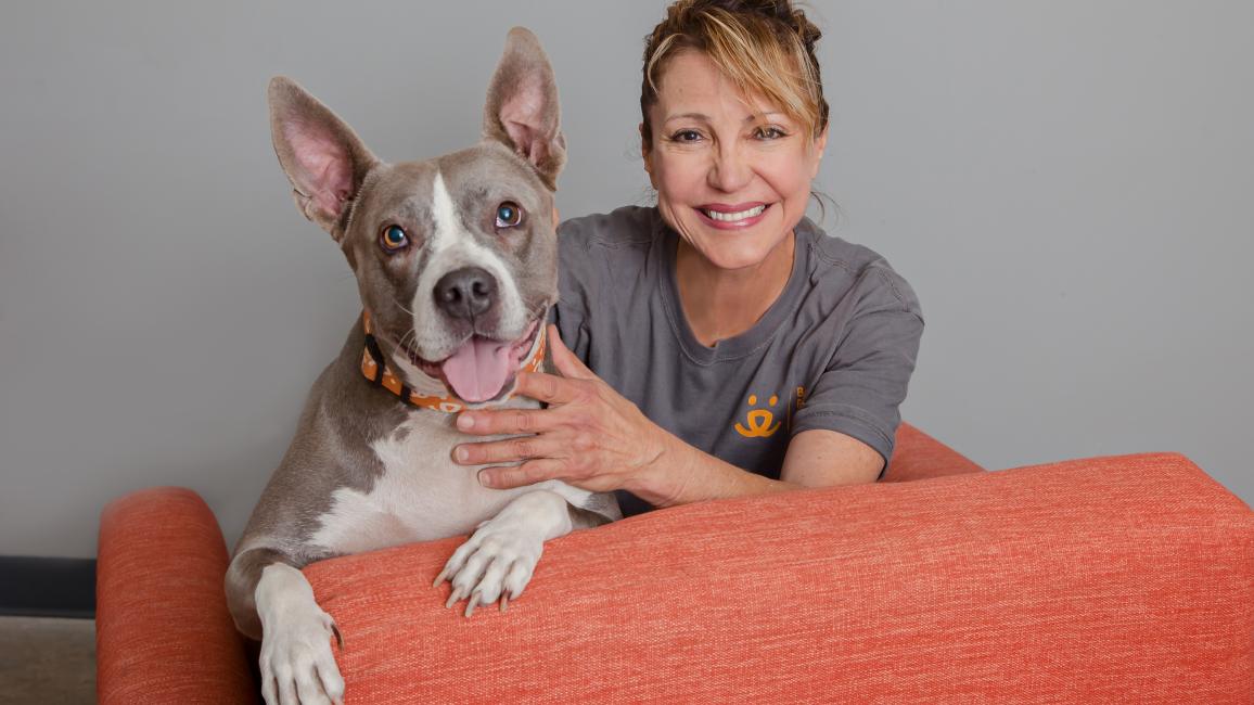 Smiling person wearing a Best Friends T-shirt next to a smiling dog with upright ears