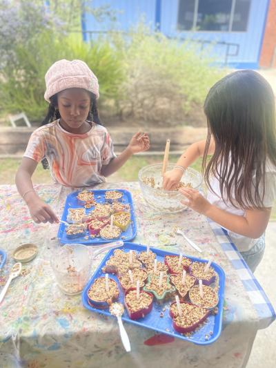 Two students getting items ready to sell for the market