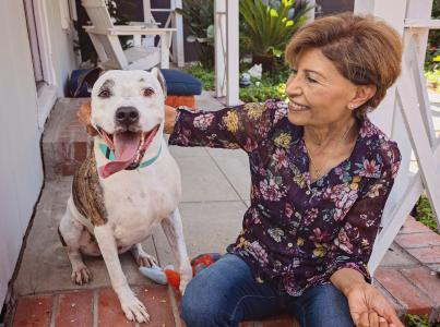 Woman sitting on porch with Los Angeles foster dog