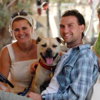 Family sitting in golf cart with Handsome Dan
