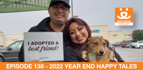 A man and woman celebrating the adoption of a dog with a sign that says "I adopted my best friend"